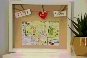 een fotoframe met een kaart en tekens erop bij Tree Apartment BG in Bergamo