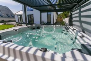 a jacuzzi tub on the back of a house at The Old Abbey in Trearddur