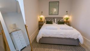 a bedroom with a large bed and a mirror at The Old Abbey in Trearddur