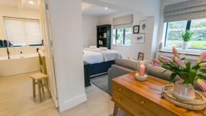 a living room with a bed and a couch and a table at The Old Abbey in Trearddur