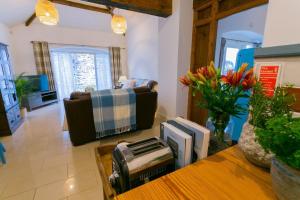 a living room with a couch and a table at Tal Y Bont Uchaf Cottage in Bangor
