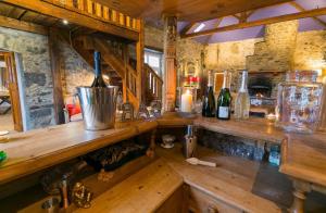a kitchen with a counter with bottles of wine at Tal Y Bont Uchaf Stables in Bangor