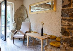 a room with a table and a chair and a mirror at Hotel Alpenhof in Oberau