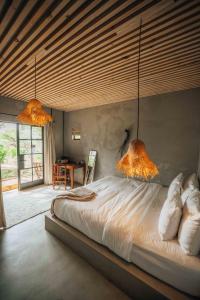 a bedroom with a large bed with two lamps at FARMHOUSE58 in Krugersdorp