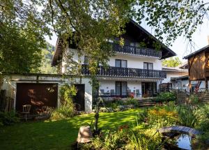 a house with a garden in front of it at Hotel Alpenhof in Oberau