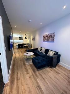 a living room with a couch and a table at Hamlet Court Apartments 1A in Southend-on-Sea