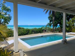a swimming pool with a view of the ocean at Villa Belvedere - 5 minutes walk to the Beach in Dickenson Bay
