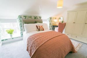 Un dormitorio con una cama y un escritorio y una ventana. en 3 Greenfield Terrace, en Menai Bridge