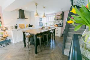 a kitchen with a large wooden table and chairs at 3 Greenfield Terrace in Menai Bridge