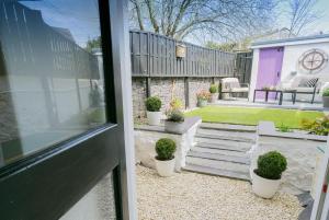 a view of a patio with potted plants in a yard at 3 Greenfield Terrace in Menai Bridge