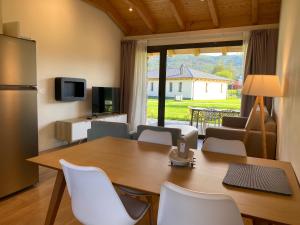 cocina y sala de estar con mesa y sillas en La Reserva de Los Campos, en Cadavedo