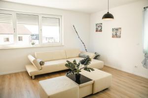a living room with a couch and a table at Shine Apartment Wackersdorf I in Wackersdorf