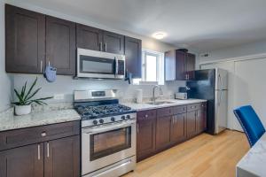 cocina con armarios de madera y horno con fogones en Modern Chicago Vacation Rental about 14 Mi to Downtown, en Chicago