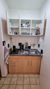 a small kitchen with a sink and a counter at Appartement zum Entspannen in Wartenberg
