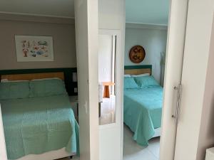 um quarto com 2 camas e um espelho em Porto de Galinhas-Muro Alto Resort em Porto de Galinhas