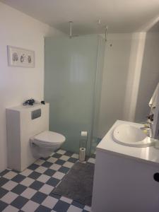 a bathroom with a toilet and a sink at Grindavik Guesthouse self check in & out in Grindavík