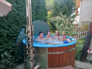 a group of four girls in a hot tub at Chata Katka in Dolný Kubín