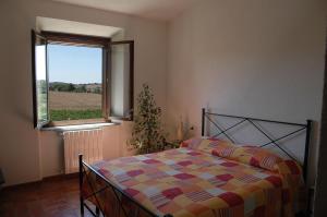 A bed or beds in a room at Agriturismo Pian dei Pini