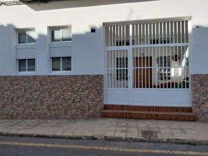 un edificio bianco con un cancello sul lato di Loft moderno en Fuerteventura a Puerto del Rosario