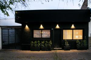 uma casa preta com luzes ao lado em Casa Rafaela Mendoza parque y ciudad em Mendoza