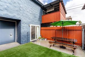 a patio with a bench and an umbrella at Casa Nova - Central San Diego FREE parking in San Diego