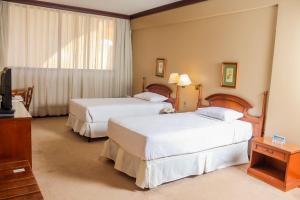 Nobile Suites Excelsior Asuncionにあるベッド