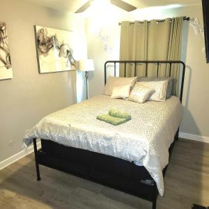a bedroom with a bed with a green towel on it at Cozy home away from home (U) in Norfolk