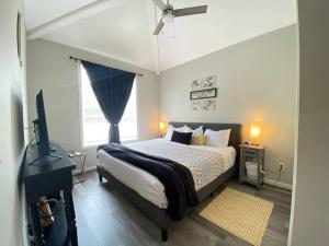 a bedroom with a bed and a television in it at Cozy Corner - Family Beach Vacation Condo in Wilmington