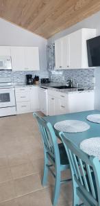 a kitchen with a table and two chairs and a sink at Old Wooden Bridge Resort & Marina in Big Pine Key