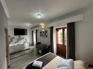 a bedroom with a bed and a bath tub in a room at Hotel San Ignacio Plaza in Tunja