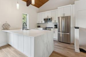 a kitchen with white cabinets and a stainless steel refrigerator at Blue View 9 Vintage Tyrolean Chalet 84152 in Blue Mountains