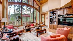 een woonkamer met meubilair en een groot raam bij Cypress Mountain Chalet in Breckenridge