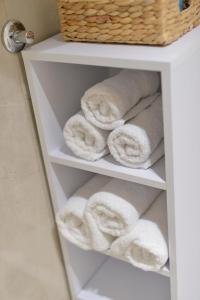 a stack of towels on a shelf in a bathroom at "Handmade" Apartment in Niš