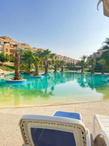 a computer monitor sitting in front of a swimming pool at Ultra Luxury 3BR with Pools ,Sports ,Dining in Gated compound, Close to all sites in Cairo