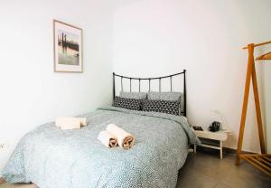 a bedroom with a bed with two towels on it at Casa Tabaiba in Tías