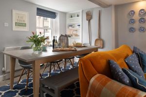 a living room with a table and a couch at Gwyndy in Beaumaris