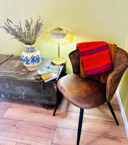 a chair sitting next to a table with a lamp at B&B Les Têtes de Mules - Adults Only in Gémenos +32 photos