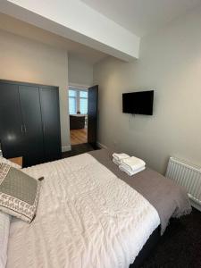 um quarto com uma cama grande e uma televisão de ecrã plano em Hamlet Court Apartment Flat 2A em Southend-on-Sea