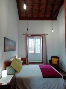 a bedroom with a large bed and a window at Finca Las Tapias, Casa Mañé in Puerto de la Cruz +61 photos
