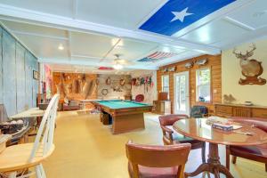 a room with a pool table and some chairs at Tennessee Farm Vacation Rental with Game Room! 