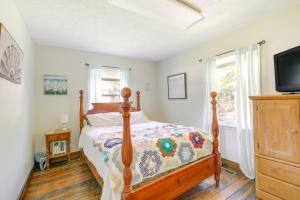 a bedroom with a bed and a flat screen tv at Tennessee Farm Vacation Rental with Game Room! 