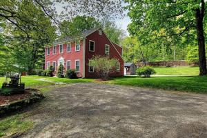 a red house with a driveway in front of it at 5 Bedroom Cozy New England home - Cobb Meadow House in Dublin