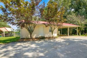 a house with a driveway and trees in front of it at Tennessee Farm Vacation Rental with Game Room! 