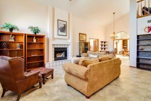 a living room with two couches and a fireplace at Albuquerque Home with Spacious Yard and Fire Pit! in Albuquerque