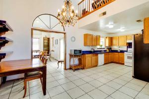 a kitchen with a table and a dining room at Albuquerque Home with Spacious Yard and Fire Pit! in Albuquerque