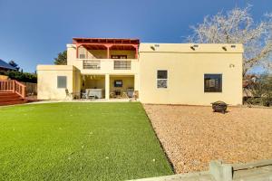 a house with a lawn in front of it at Albuquerque Home with Spacious Yard and Fire Pit! in Albuquerque