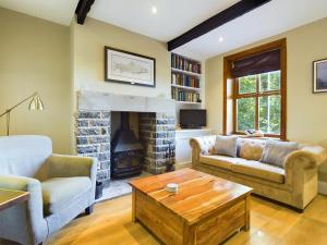a living room with two couches and a fireplace at Stoneswood Cottage & Garden, Delph, Saddleworth in Delph
