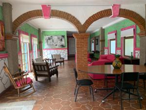 a living room with a table and chairs at Mesón Yollotl in Puebla +43 photos