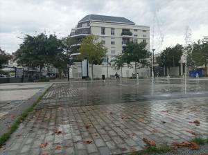 a water fountain in front of a building at TheCALC Homes 2Bedroom+1Kitchen in Sartrouville