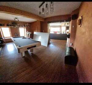 a living room with a ping pong table in it at Gee's Shared home in Liège